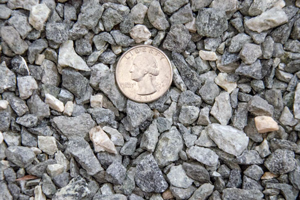 limestone rocks with quarter used for scale
