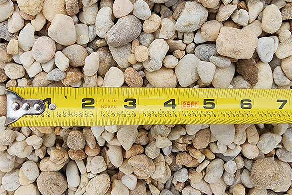 river rock with tape measure to show scale